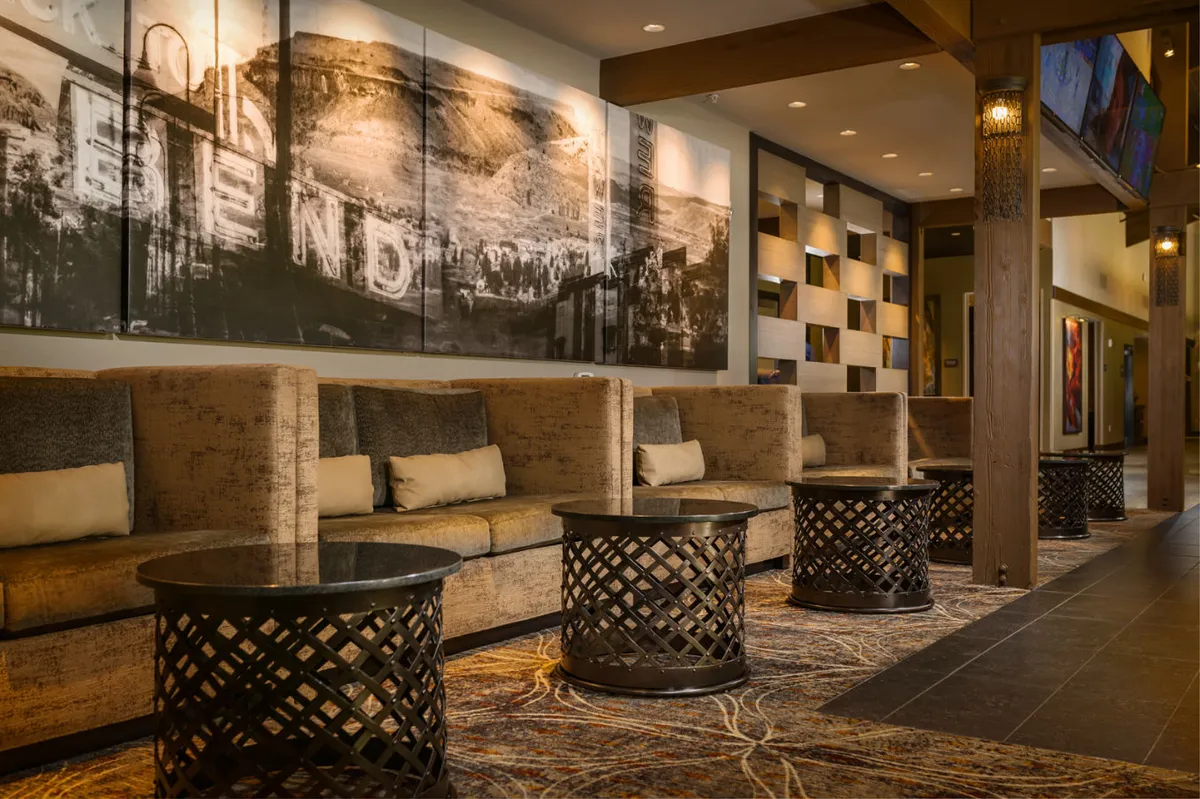 A cozy interior lounge with plush sofas, coffee tables, and contemporary artwork, perfect for relaxing, reading, or socializing in a comfortable environment.
